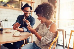 Happy couple looking at smart phone