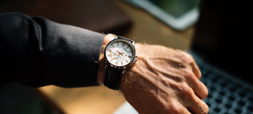 Man checks the time on his wristwatch.