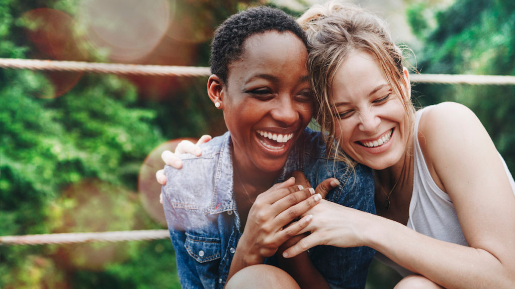 Girlfriends Laughing and Embracing