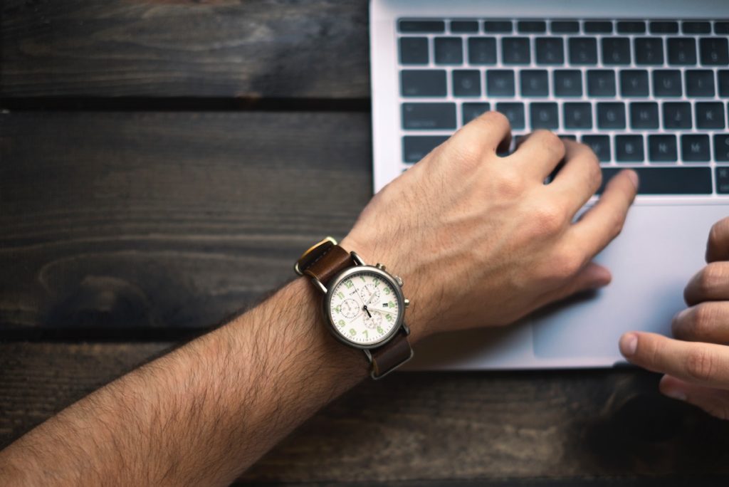 Man Typing on Computer with Watch Face Visible