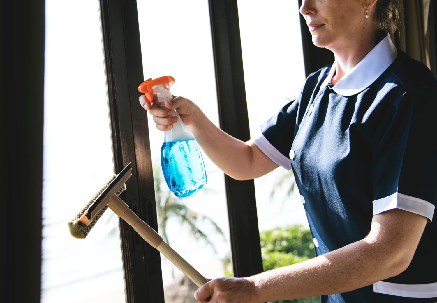 Housekeeper cleaning a hotel room