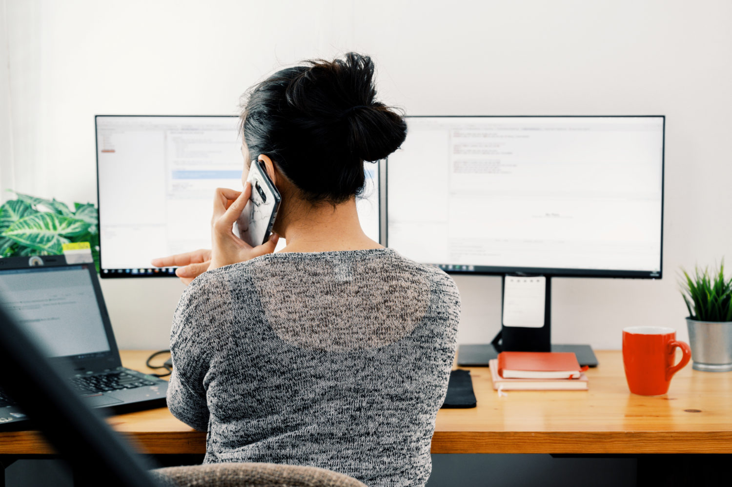 woman working at double monitors