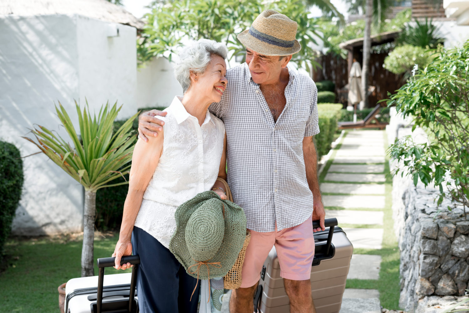 senior couple walking side by side at hotel