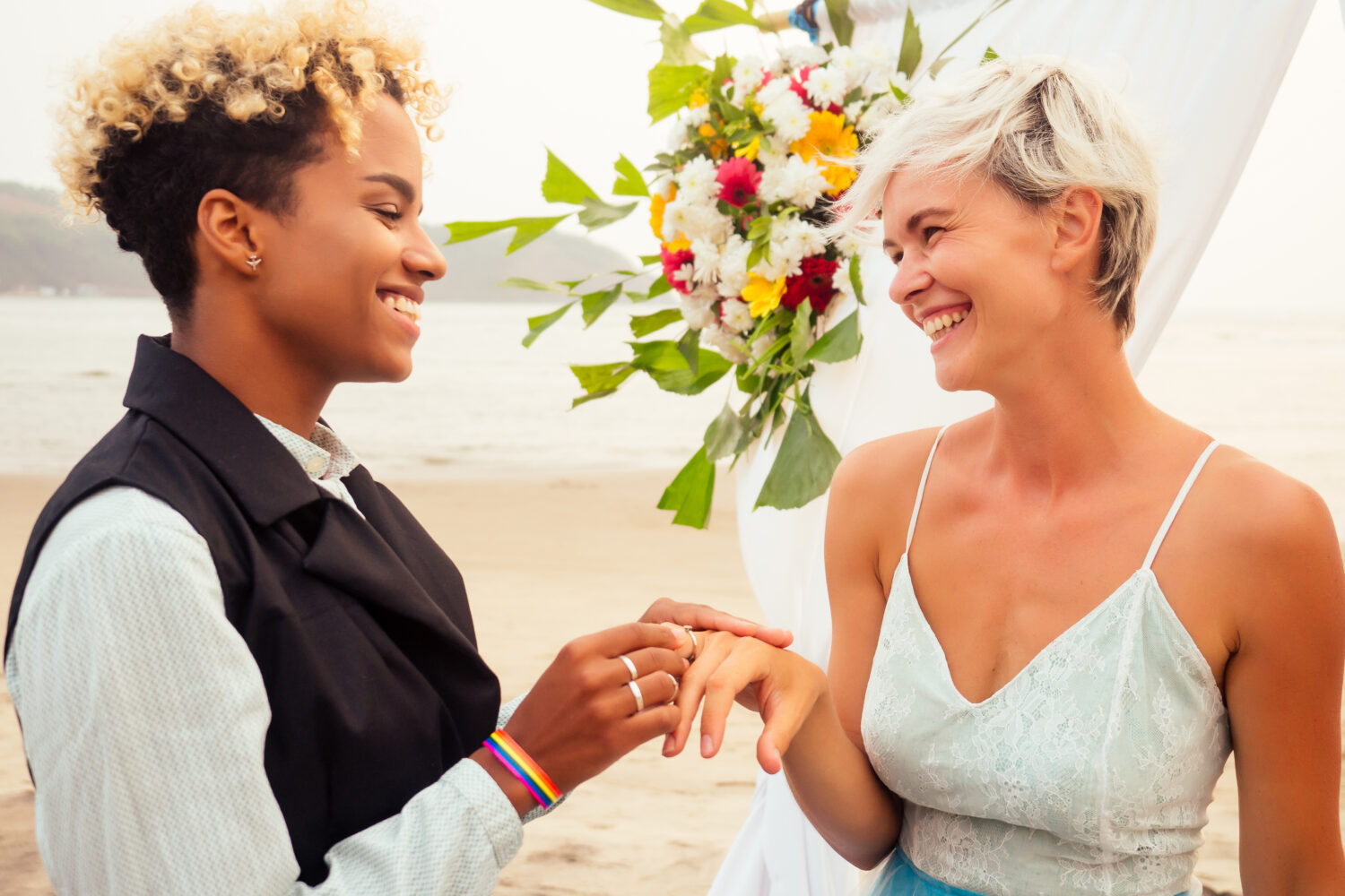 african american woman putting a ring on her girlfriend