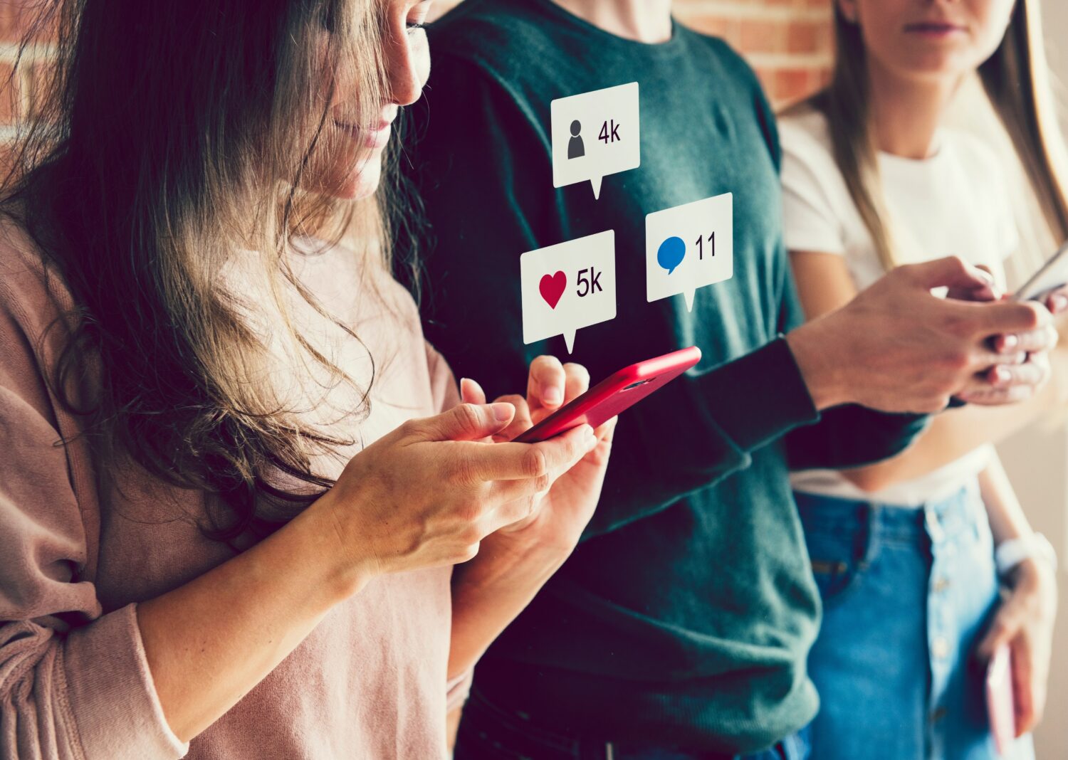 A girl using a phone with likes, comments, and follower counts edited in to float above the phone