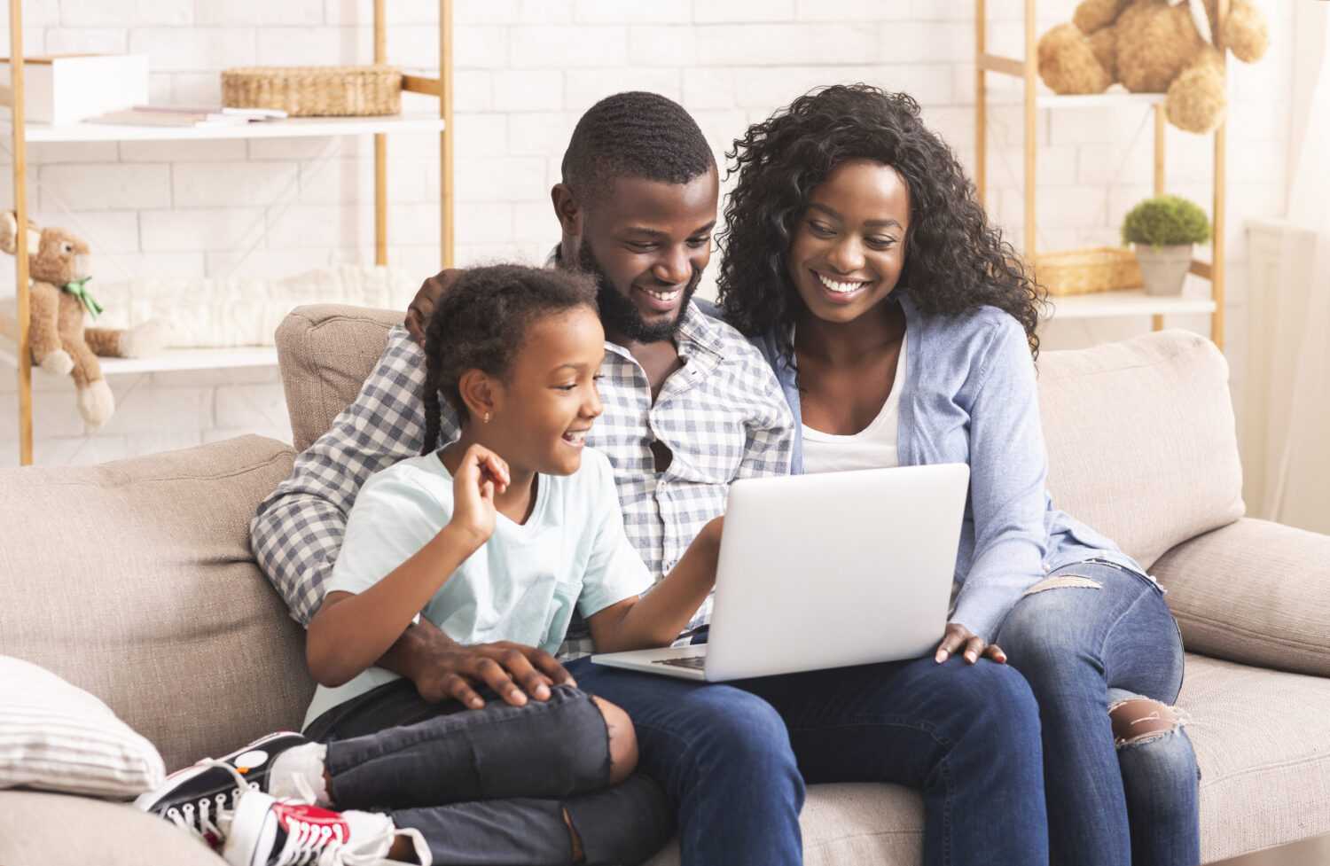 black family looking at a laptop and smiling
