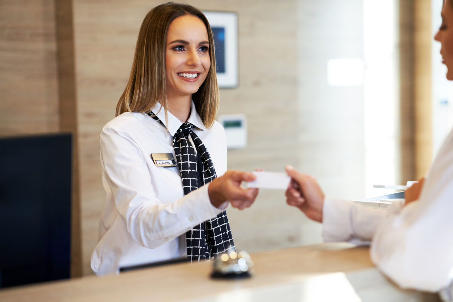 receptionist accepting payment from guest at front desk