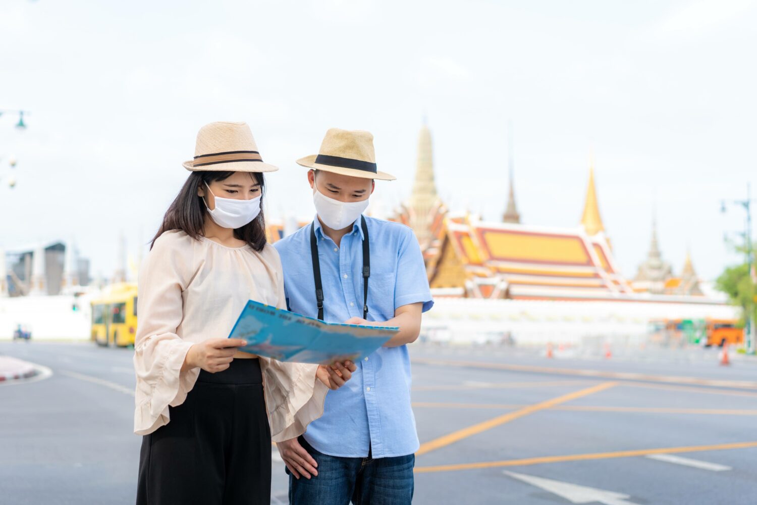 couple sharing a map while masked