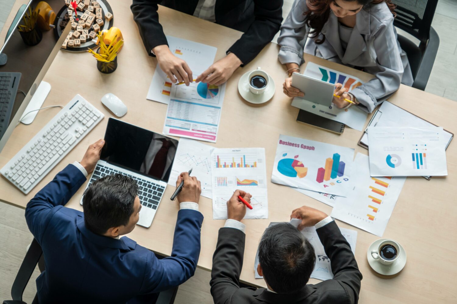 top-down photo of business people reviewing analytics paperwork