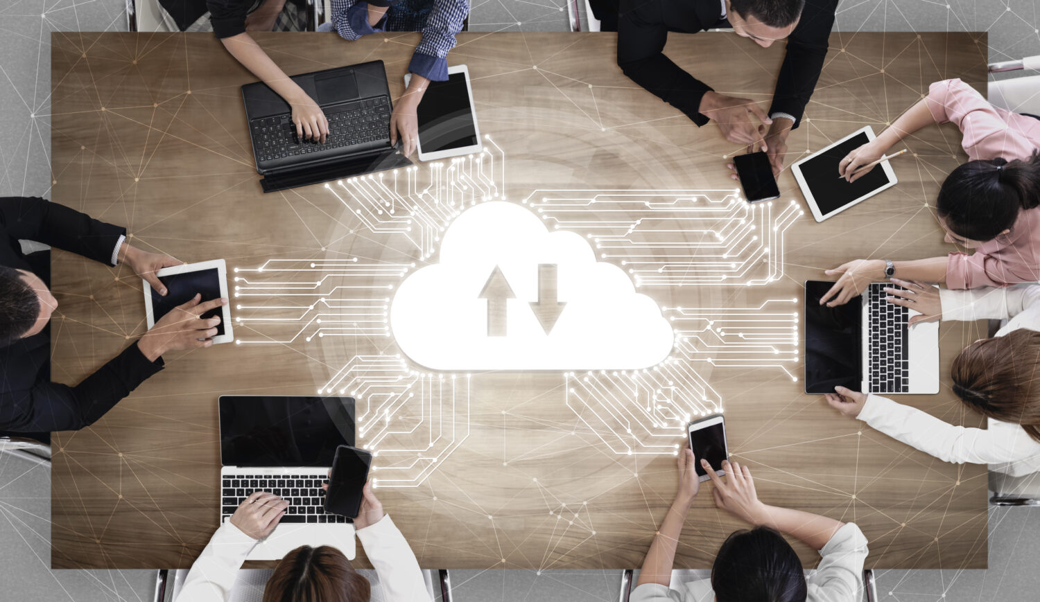 top-down photo of a group of employees on laptops and phones