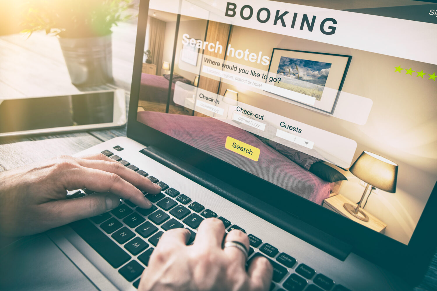 hands typing on a computer that displays a booking screen