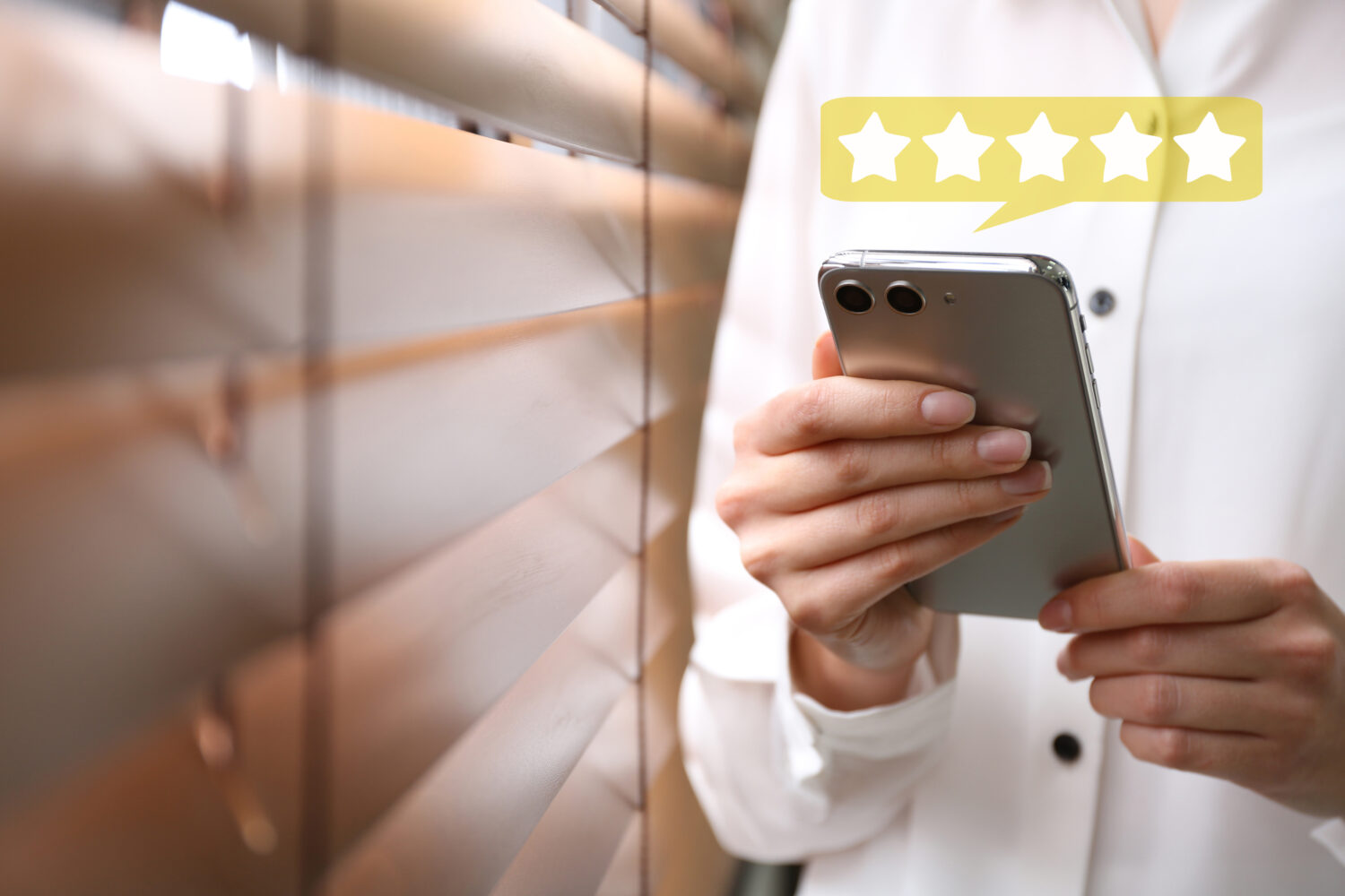 close crop of a man using a phone with a 5-star rating floating above