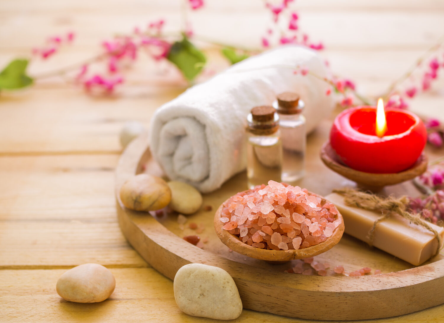 aromatherapy set sitting on a wooden table surrounded by flowers