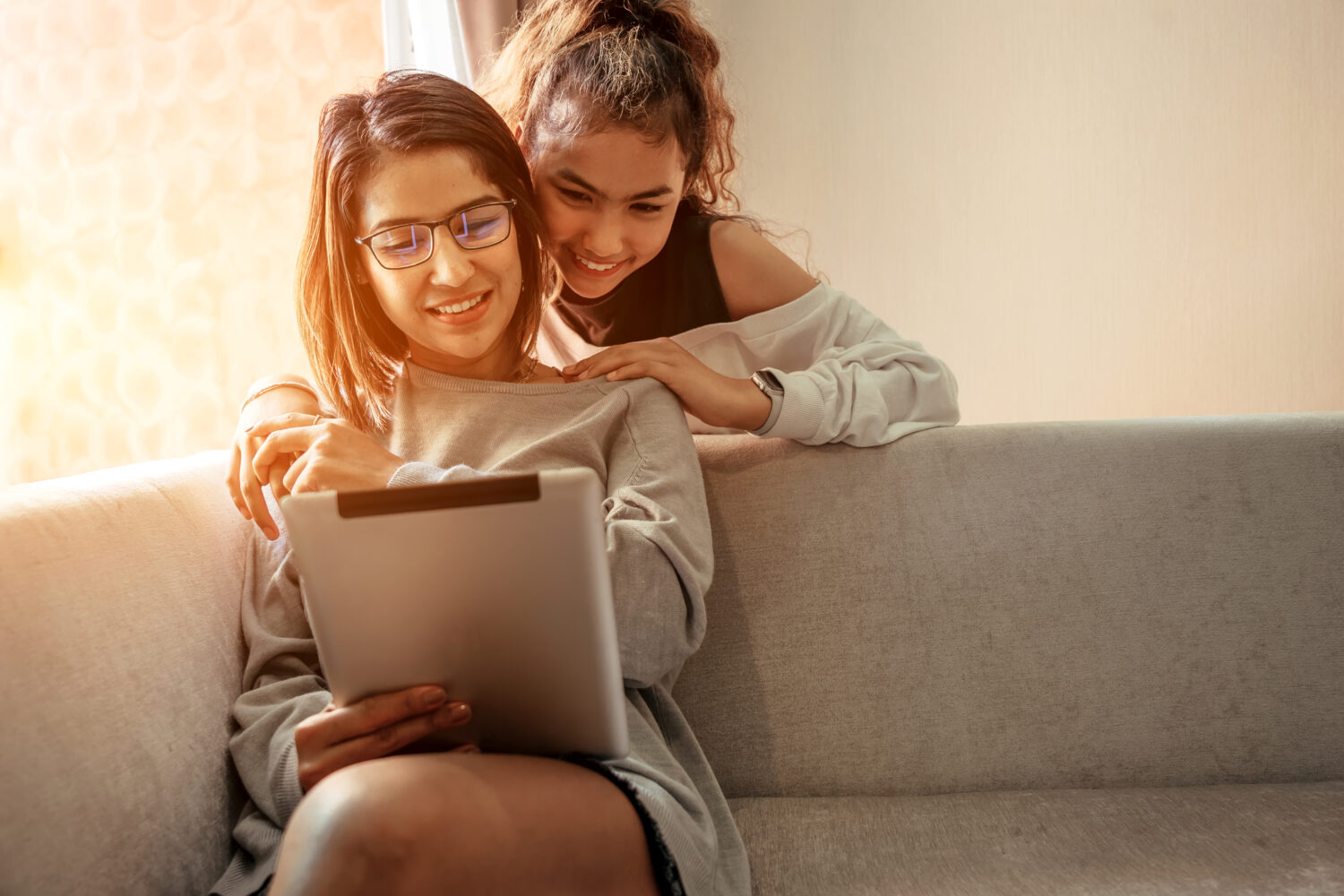 mom and daughter hugging on couch 