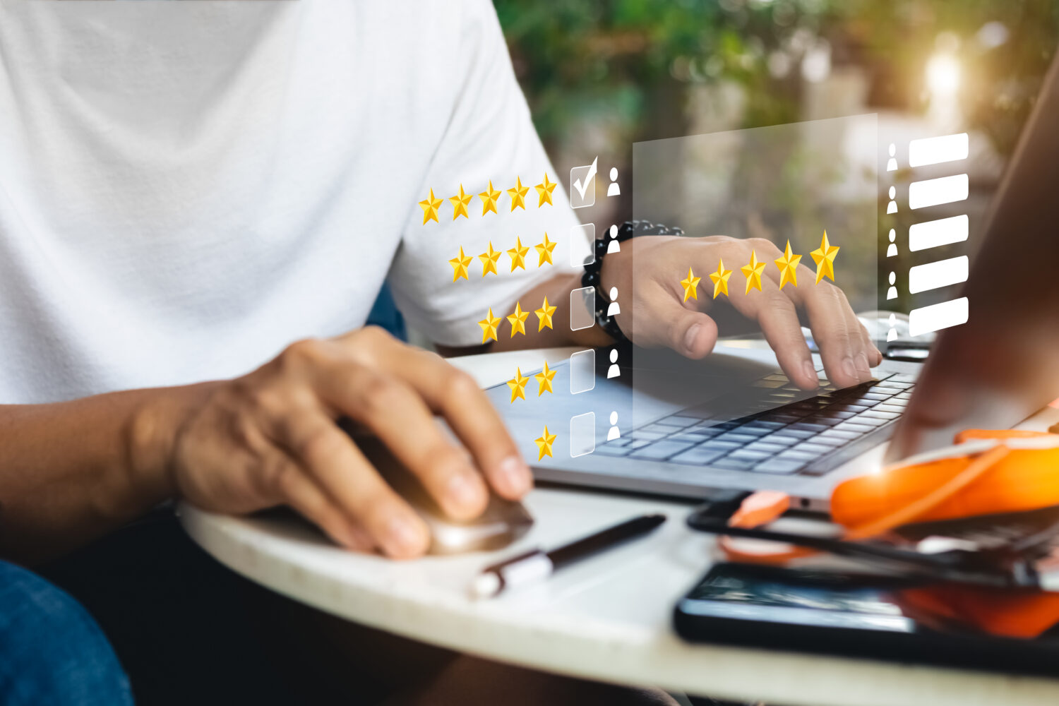 man using a laptop with ratings surrounding his hands