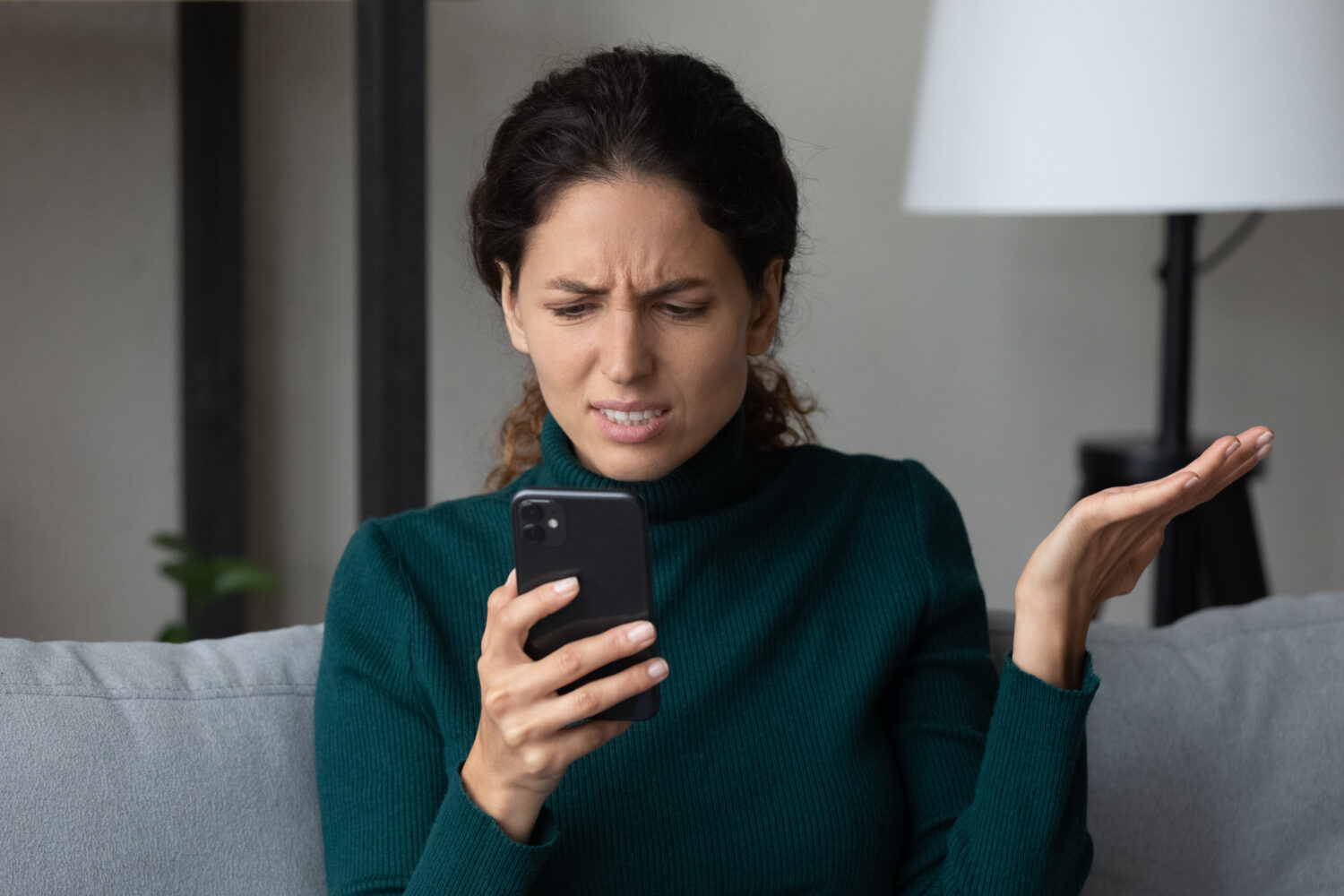 Close up angry dissatisfied woman looking at phone screen