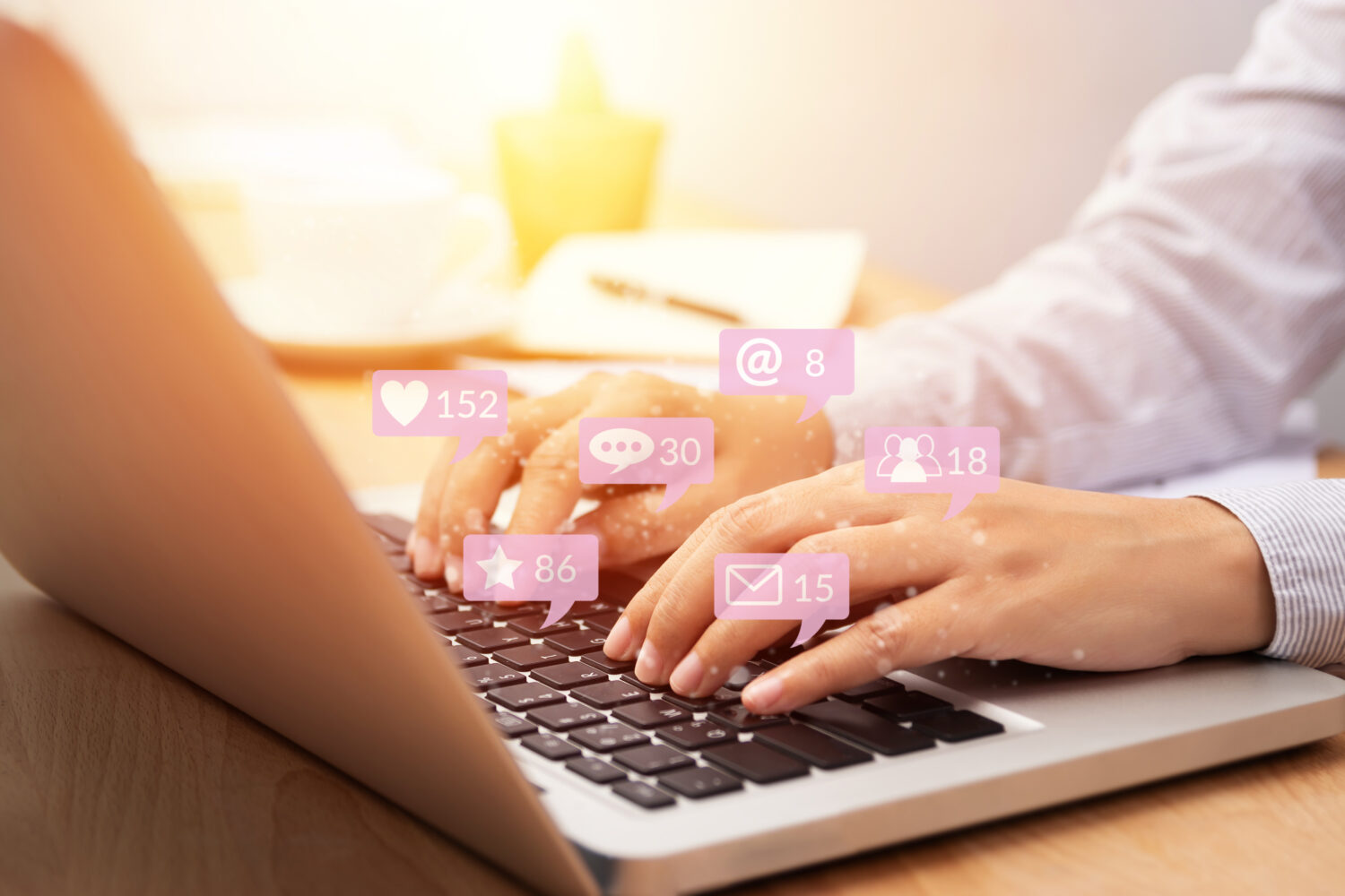 person using a laptop with floating social media icons floating out